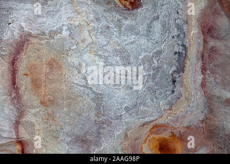 Background from a rough stone pattern on the wall with iridescent yellow, beige, orange and gray. Design and architecture. Stock Photo