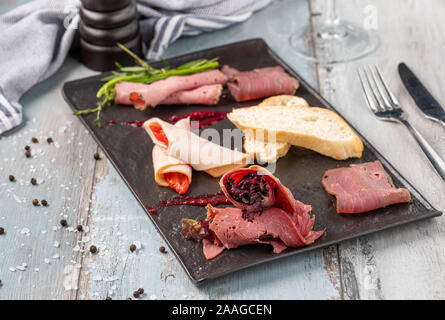 Appetizers table with italian antipasti snacks and wine in glasses Stock Photo