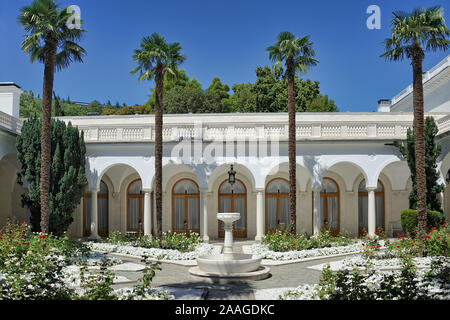 = Italian Courtyard with Palms =  View of Italian Courtyard with palms and fountain for walk and relation in Livadia Palace, the summer residence of R Stock Photo