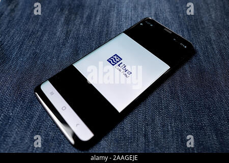 Odessa, Ukraine - October 26, 2019: Libra app. Libra logo visible on smartphone screen. Denim background. Soft focus Stock Photo