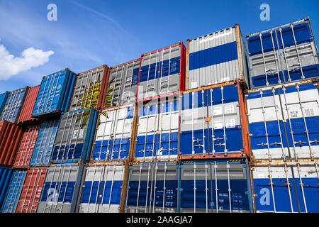 The national flag of Uruguay on a large number of metal containers for storing goods stacked in rows on top of each other. Conception of storage of go Stock Photo