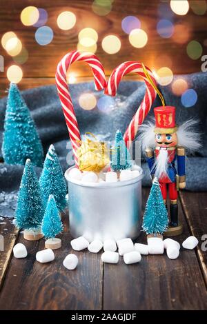 Christmas marshmallows and new year decorations on wood background with grey plaid. Winter holidays Stock Photo