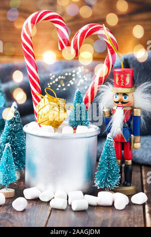 Christmas marshmallows and new year decorations on wood background with grey plaid. Winter holidays Stock Photo