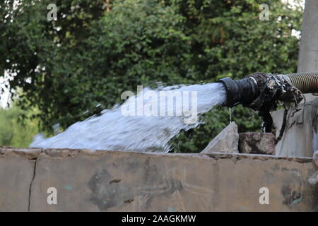 crystal clear sweet and healthy water being flush out, Water flowing in pipe from well Stock Photo