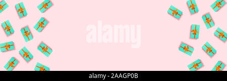 Christmas banner with mint boxes located on pink background. Stock Photo