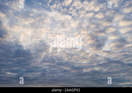 Fluffy clouds in the blue sky at evening Stock Photo