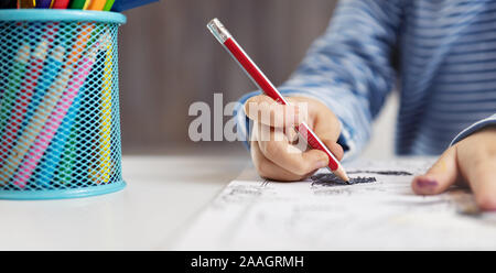 Little child at home drawing on the paper Stock Photo