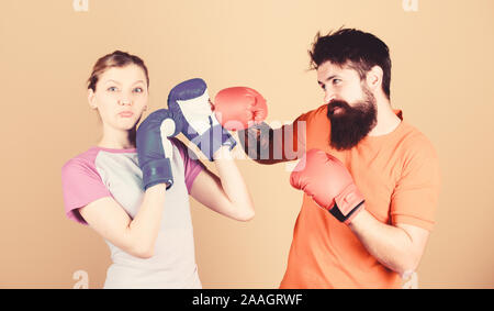 Amateur boxing club. Equal possibilities. Strength and power. Man and woman in boxing gloves. Be careful. Boxing sport concept. Couple girl and hipster practicing boxing. Sport for everyone. Stock Photo