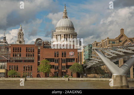 LONDON, UK - SEPTEMBER 08, 2017: St Pauls Cathedral and the Millennium Bridge in London, United Kingdom during a cloudy day. Stock Photo