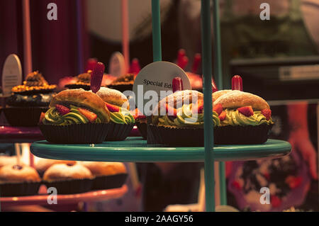 Assorted donuts with chocolate frosted and glazed on hte shelf in bakery shop. Stock Photo