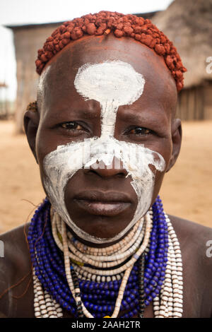 Ethiopia, South Omo, Kolcho village, face of traditionally decorated Karo tribal woman with ochre in hair Stock Photo