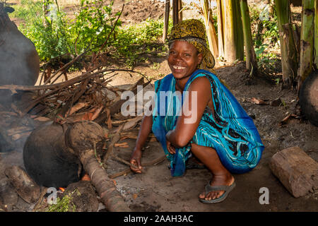 Ethiopia, South Omo, Jinka, Yenegrew Sew Aari village, smiling woman with home made still making araki alcoholic spirit Stock Photo