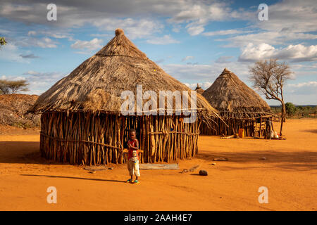 Ethiopia, South Omo, Turmi, Hamar tribal village, child outside traditional wooden house with thatched roof Stock Photo