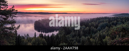 Scenic landscape with lake, sunrise and fog at tranquil misty morning in Aulanko, nature reserve, Finland Stock Photo