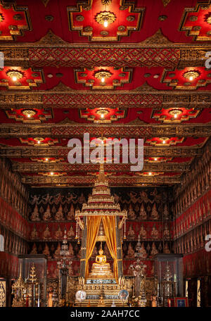 OCT 24, 2019 Bangkok, Thailand - Bangkok National Museum Thai antique Siamese Phra Phuttha Sihing royal Buddha sculpture under red gold pavillion with Stock Photo