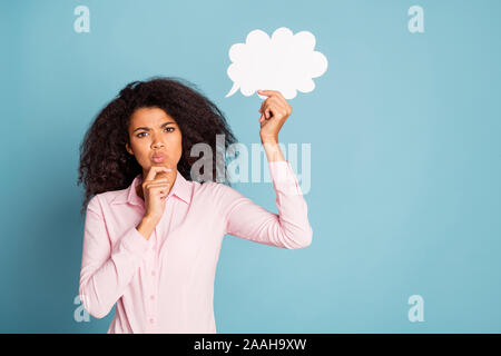 Photo of funny pretty dark skin model lady holding paper cloud mind thinking over creative dialogue answer arm touch chin wear pink shirt isolated Stock Photo
