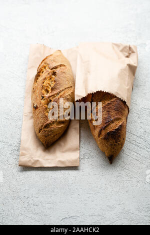 whole wheat two breads and bun on a wicker plate Stock Photo - Alamy
