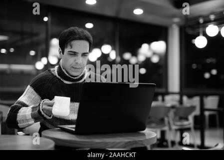 Handsome Persian man relaxing at the coffee shop Stock Photo