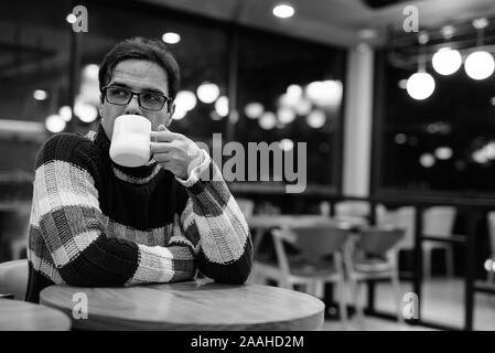 Handsome Persian man relaxing at the coffee shop Stock Photo