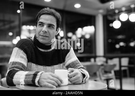 Handsome Persian man relaxing at the coffee shop Stock Photo