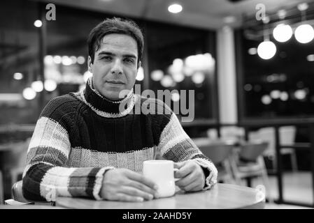 Handsome Persian man relaxing at the coffee shop Stock Photo