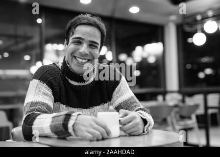 Handsome Persian man relaxing at the coffee shop Stock Photo