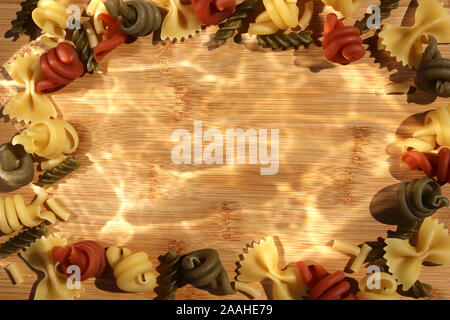 Trottole, Fusilli and Farfalle dried pasta background frame border Stock Photo