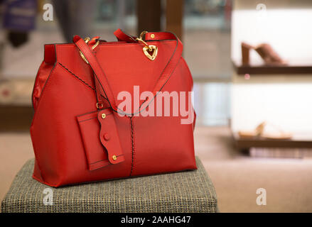 Ladies Red Color Leather Hand Bag in a Store Stock Photo