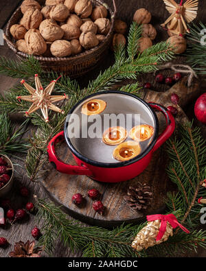 Candles made from nut shells floating in water - old Christmas custom Stock Photo