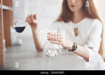 Experiments in the chemical laboratory. An experiment was carried out in a laboratory in transparent flasks Stock Photo