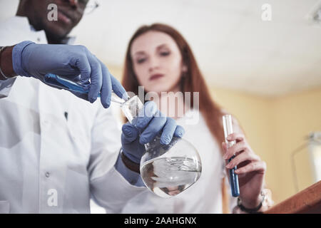 Experiments in the chemical laboratory. An experiment was carried out in a laboratory in transparent flasks Stock Photo