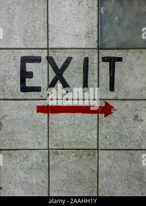 Exit and red arrow painted on a tiled wall in Nicholas Building Melbourne Victoria Australia. Stock Photo