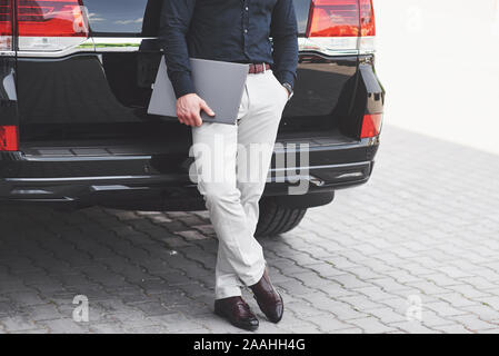 Portrait of a beautiful man in business clothes standing outside in the office. Stock Photo