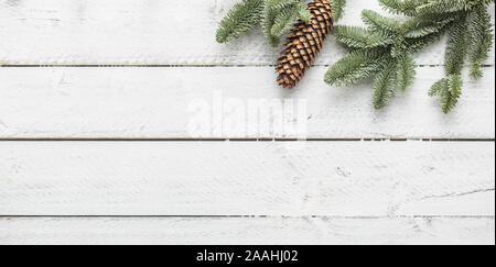 Christmas background twigs and pine cone on wooden background - Top of view. Stock Photo