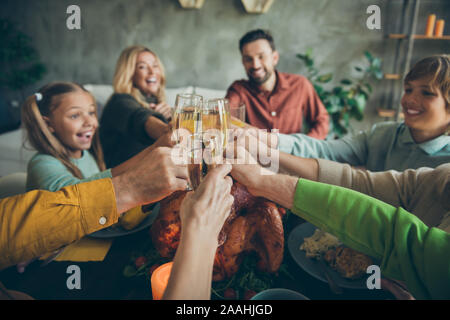 First point view of big family small little kids mature pensioners gather sit table celebrate thanksgiving day enjoy october fall feasting meal hold Stock Photo