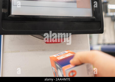 close up consumer check the price in the store using rfid scanners Stock Photo