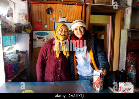 JAMMU KASHMIR, INDIA - MARCH 20 : Travelers thai women journey visit and posing portrait with Tibetan people owner local shop at Nubra village valley Stock Photo