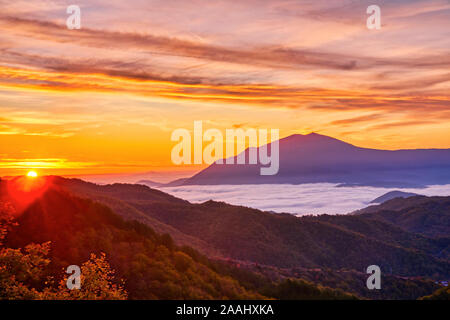 Amazing Sunrise Over Misty Landscape. Scenic View Of Foggy Morning Sky With Rising Sun Above Misty Forest. Rhodope Mountains. Xanthi Thrace, Greece Stock Photo