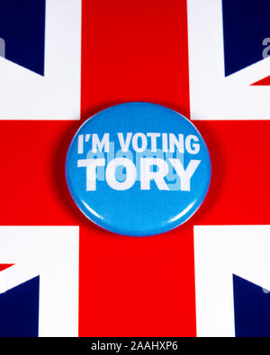 London, UK - November 21st 2019: I’m Voting Tory pin badge, pictured over the United Kingdom flag. The UK General Election is taking place on 12th Dec Stock Photo