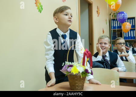 Tyumen, Russia - September 1, 2019: Gymnasium number 5. Students of elementary school in uniform in classroom at knowledge day - September First Stock Photo