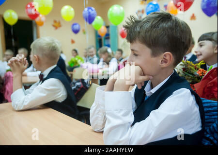 Tyumen, Russia - September 1, 2019: Gymnasium number 5. Students of elementary school in uniform in classroom at knowledge day - September First Stock Photo