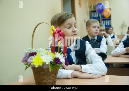 Tyumen, Russia - September 1, 2019: Gymnasium number 5. Students of elementary school in uniform in classroom at knowledge day - September First Stock Photo