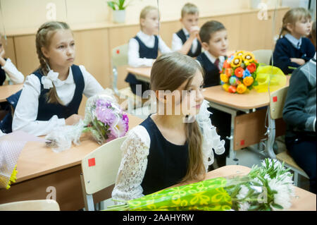 Tyumen, Russia - September 1, 2019: Gymnasium number 5. Students of elementary school in uniform in classroom at knowledge day - September First Stock Photo