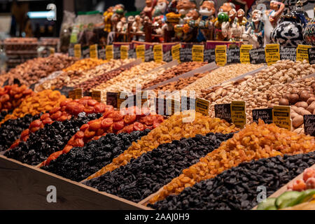 Dried fruits on the market shelves. Bright tasty delicacies. Dried apricots, raisins, prunes and nuts in the eastern bazaar. Stock Photo