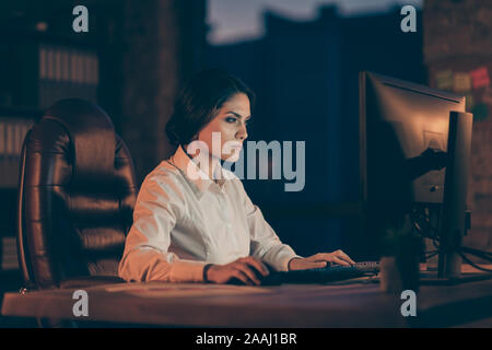 Profile side view portrait of her she nice attractive focused concentrated smart clever intelligent busy lady hardworking typing creating new Stock Photo