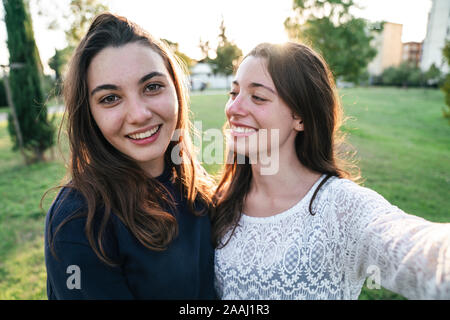 Sisters spending time together in park Stock Photo