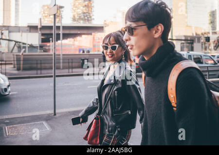 Young couple walking on street, Milan, Italy Stock Photo