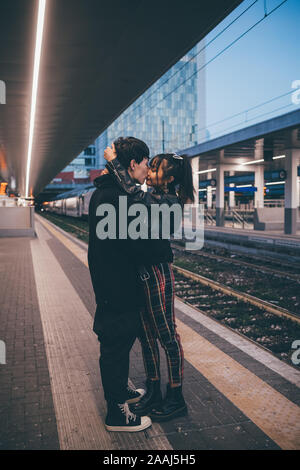 Young couple kissing on train station platform, Milan, Italy Stock Photo