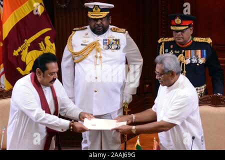 (191122) -- COLOMBO, Nov. 22, 2019 (Xinhua) -- Sri Lanka's former president Mahinda Rajapaksa (L, front) who was appointed as new prime minister is appointed as the new minister of Finance, Economic Affairs, Policy Development, Buddha Sasana, Cultural, Water Supply and Urban Development and Housing Affairs at the Presidential Secretariat in Colombo, Sri Lanka, Nov. 22, 2019. Sri Lankan President Gotabaya Rajapaksa on Friday appointed a new 16 member cabinet which will function till the next parliamentary election is announced. The new ministers took oaths in front of the president at the Presi Stock Photo