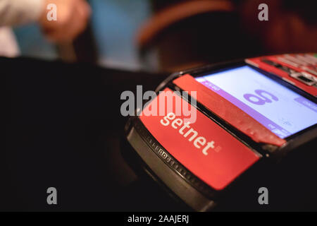 Editorial photo. Getnet card machine on a wooden furniture. Stock Photo